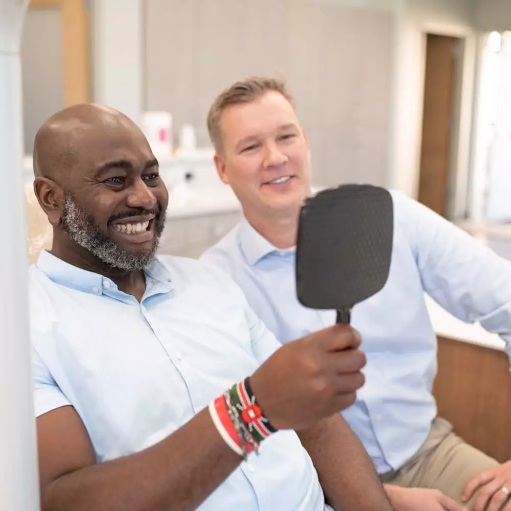 patient smiling looking at mirror